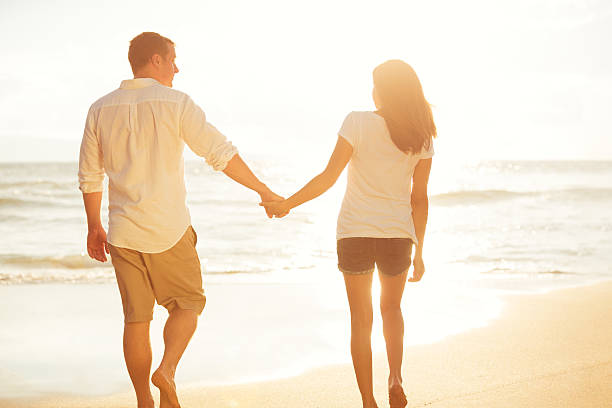 istock Couple Walking on the Beach at Sunset 488107978