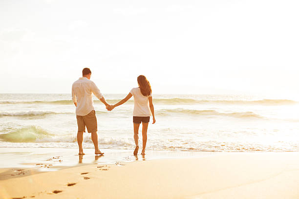 istock Couple Walking on the Beach at Sunset 488108032