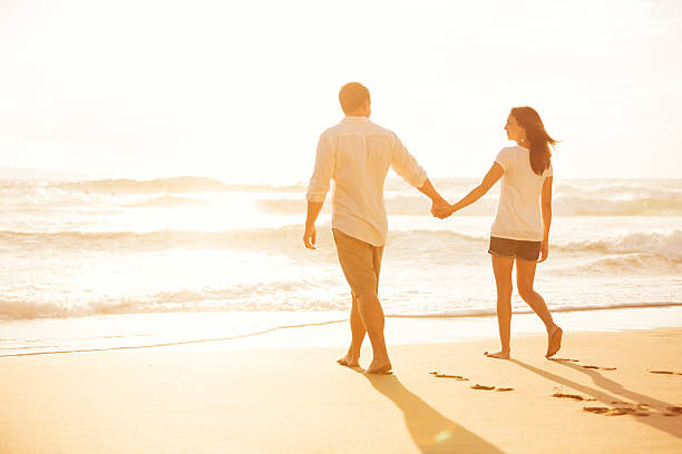 istock Couple Walking on the Beach at Sunset 488108088