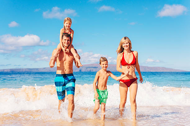istock Happy Family Having Fun on the Beach 488109492