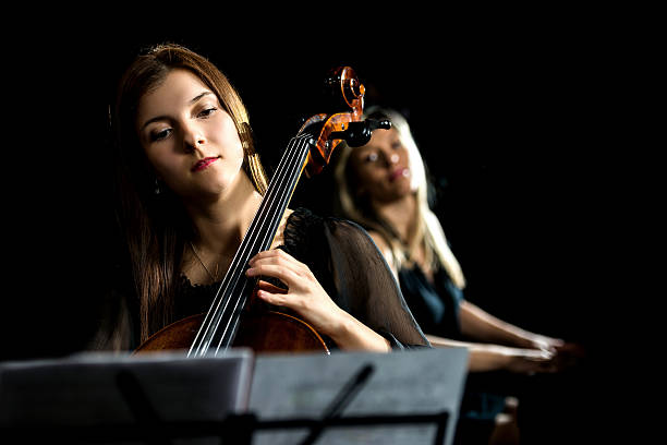 istock Young woman playing cello. 488109560