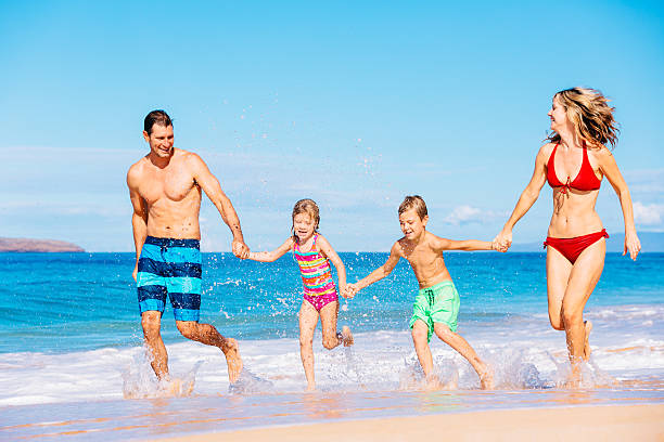 istock Happy Family Having Fun on the Beach 488109638
