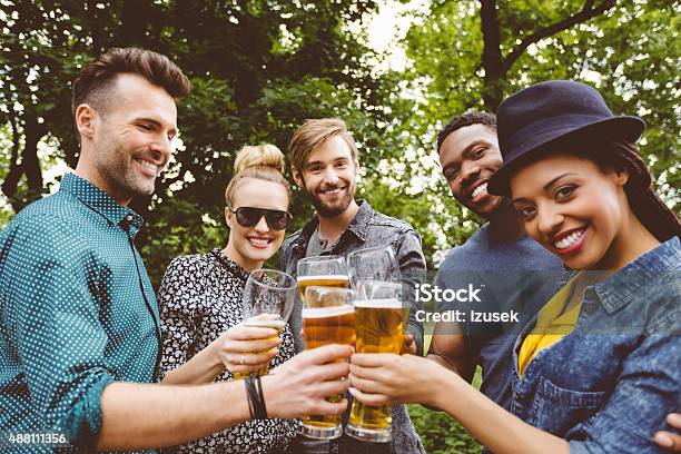 Multi Ethinc Friends Toasting With Beer Outdoors Stock Photo - Download Image Now - Beer Glass, Celebratory Toast, Summer
