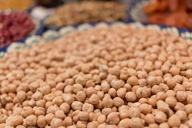 Dried fruits and chick peas on plates. Closeup of macro shot.