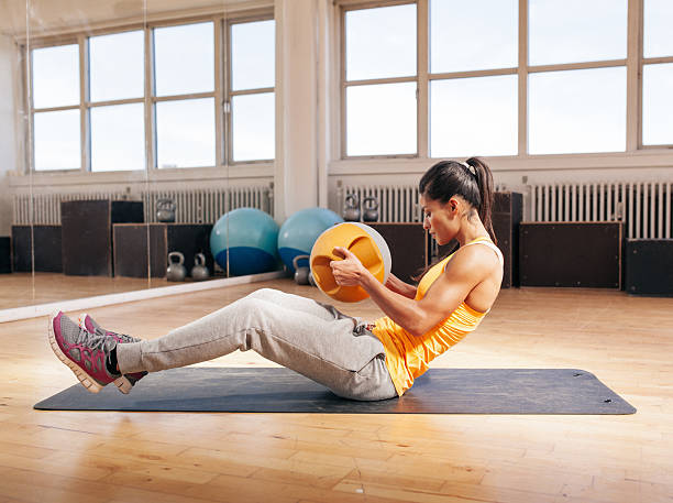 istock Young fitness woman exercising in gym 488114708