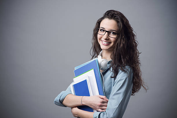 istock Beautiful student girl posing with notebooks 488115362