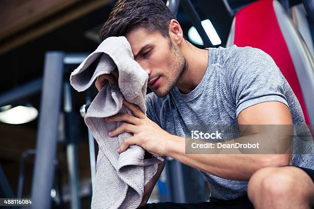 Man Sitting On The Bench With Towel Stock Photo - Download Image Now - Exercising, Towel, 2015