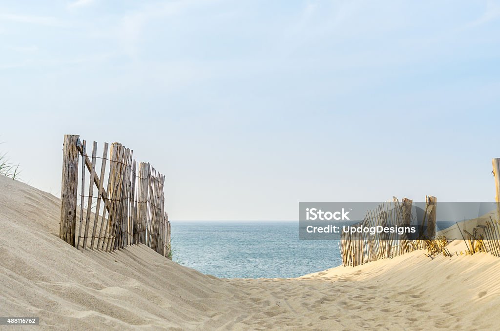 Cape Cod Two Fences two fences frame the pathway to the beach at Provincetown Massachusetts, at sunset Beach Stock Photo