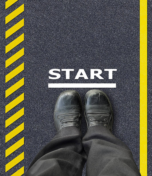 istock man with shoes standing on asphalt background 488118925