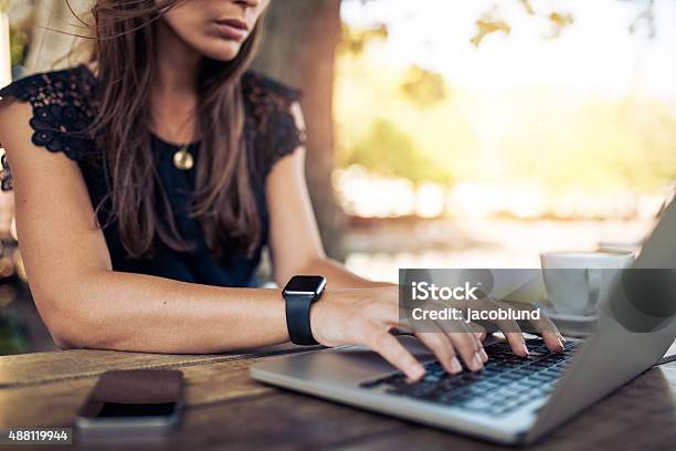 Woman Working On Laptop In A Cafe Stock Photo - Download Image Now - Smart Watch, Laptop, Women