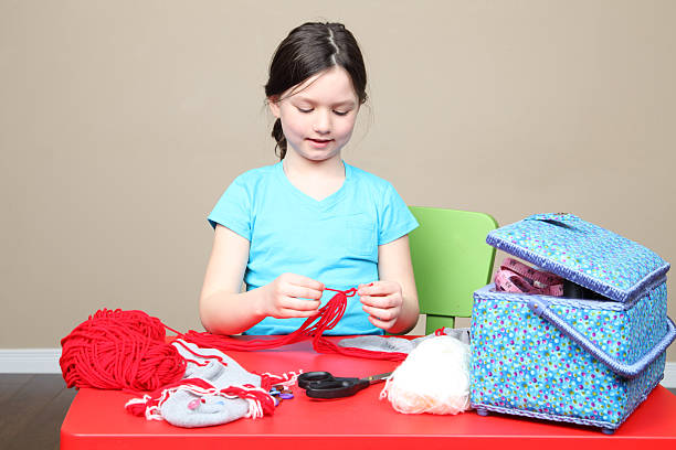 istock A young girl tying some yarn to make something 488120581