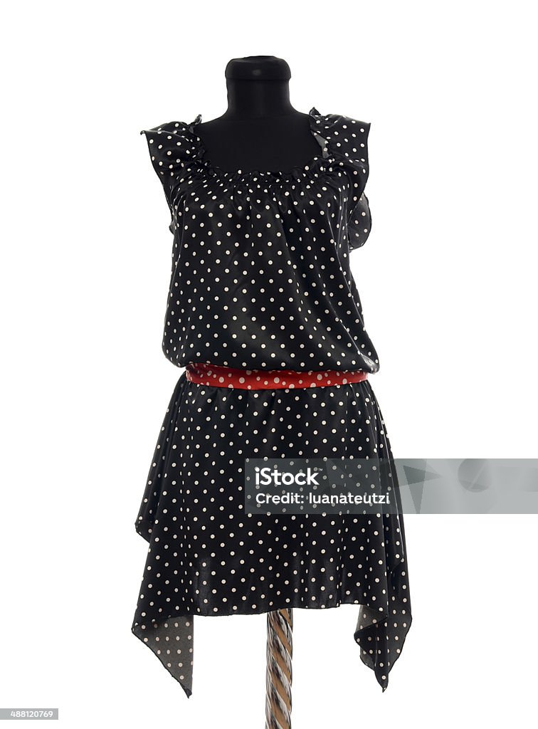 Polka dots dress with red belt on mannequin. Woman summer outfit on tailor's dummy isolated on white background. Black Color Stock Photo