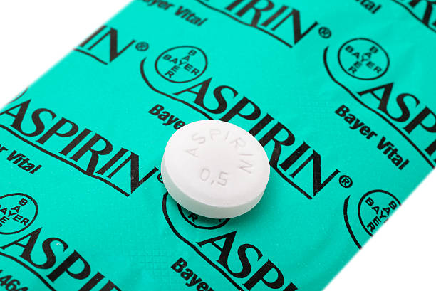 Half gram Aspirin tablet on backside of its blister pack Idar-Oberstein, Germany - May 3, 2014: One Aspirin tablet, containing 0.5 gram of acetylsalicylic acid as  active pharmaceutical ingredient, located on the backside of its blister pack with ten tablets. Aspirin is one of the most common and used pharmaceutical drugs worldwide. In 1897 Aspirin was first synthesized by the german company Bayer. It was mainly used to relieve pain and aches, but today it is also known to help to lower the risk for strokes, heart attackes and maybe some type of cancer if taken in low dosis regulary. The pictured pack is the one sold in Germany. bayer schering pharma ag photos stock pictures, royalty-free photos & images