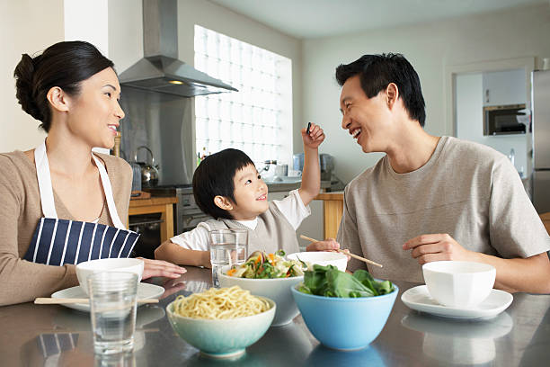 istock Happy Young Family Enjoying Meal 488124115