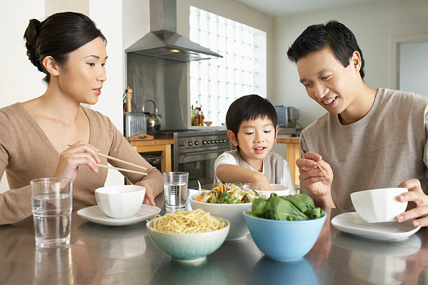 istock Young Family Enjoying Meal 488124121