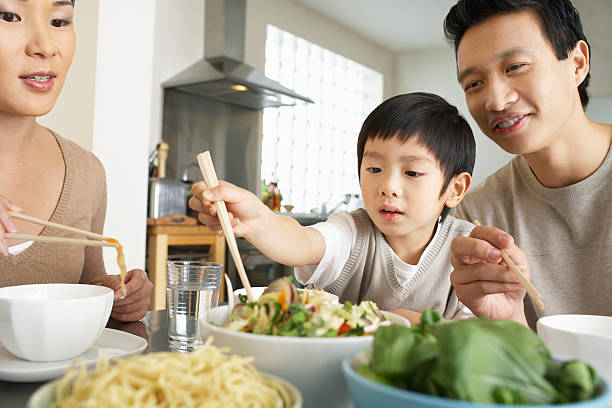 istock Young Family Enjoying Meal 488124127