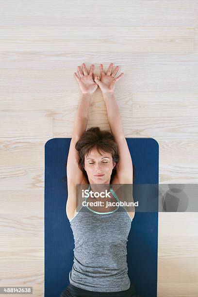 Fitness Woman Exercising On Yoga Mat Stock Photo - Download Image Now - Yoga, Women, Arms Raised