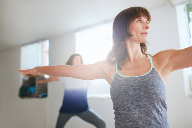 istock Women exercising at yoga class 488142932