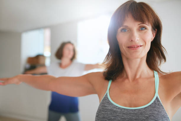 istock Women doing yoga workout at gym 488143022