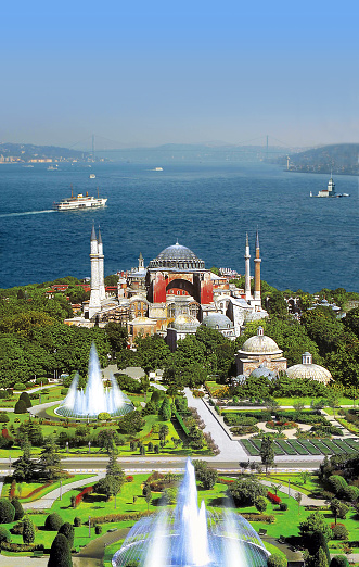 Beyoglu historic district and Galata tower medieval landmark with sightseeing ships. Istanbul, Turkey.