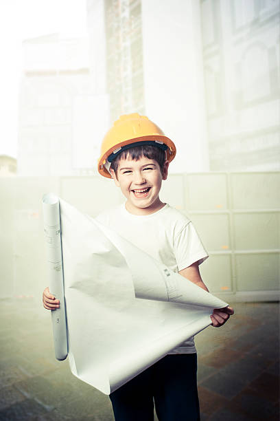 architect boy holding blueprint stock photo