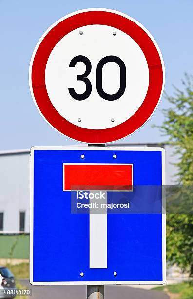 Speed Limit And Dead End Traffic Signs Stock Photo - Download Image Now - 2015, Blue, City Street