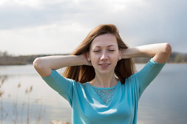 istock Freckled happy girl with closed eyes 488144532