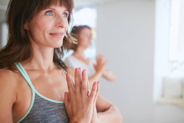 istock Women in tree pose yoga with Namaste 488144970
