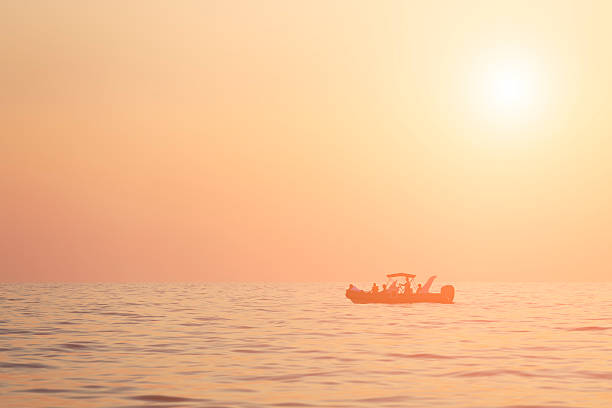 istock Boat in the sea at sunset 488146052