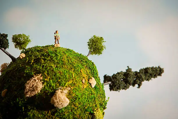 Diorama depicting a hiker on a miniature earth