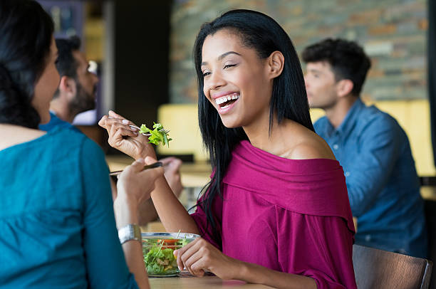 istock Young beautiful woman eating salad 488151178