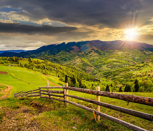 istock fence on hillside meadow in mountain at sunset 488151806