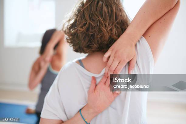 Women At Yoga Class Practicing Gomukhasana Stock Photo - Download Image Now - 2015, Adult, Back