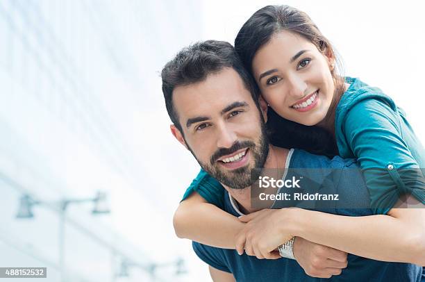 Young Man Piggyback Her Girlfriend Stock Photo - Download Image Now - Young Couple, Couple - Relationship, Smiling