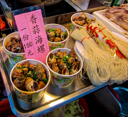 Snails and noodles for sale at Shilin Night Market, Taipei, Taiwan, 2013.