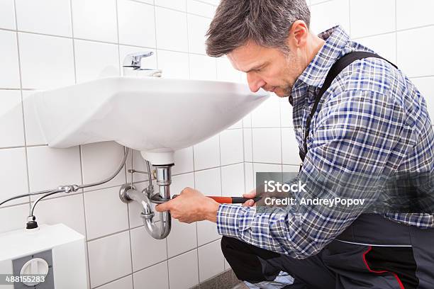 Plumber Fitting Sink Pipe Stock Photo - Download Image Now - Plumber, Business, Building Contractor