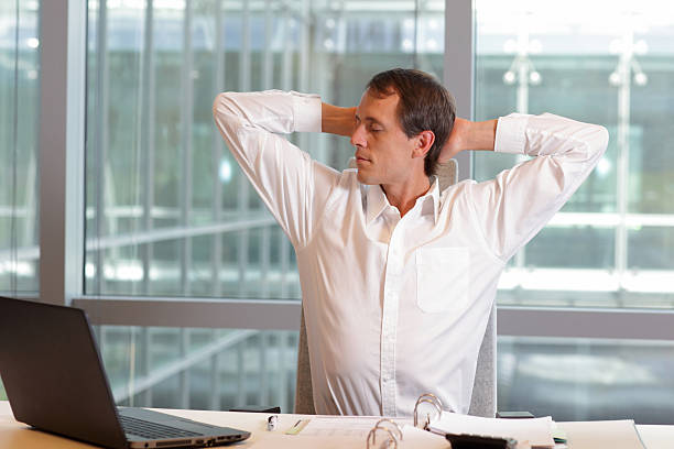 istock white collar worker male stretching arms, relaxing neck 488155520