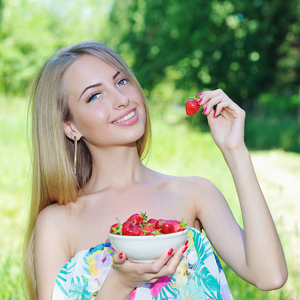 istock Happy girl with strawberries 488156760