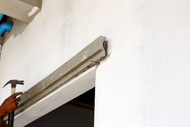 istock plasterer concrete worker at wall of house construction 488156791