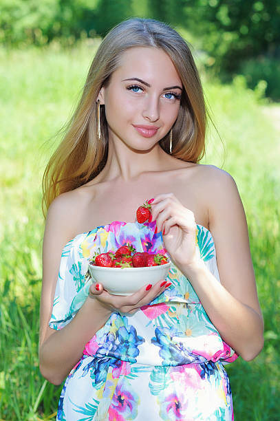 istock Happy girl with strawberries 488156828