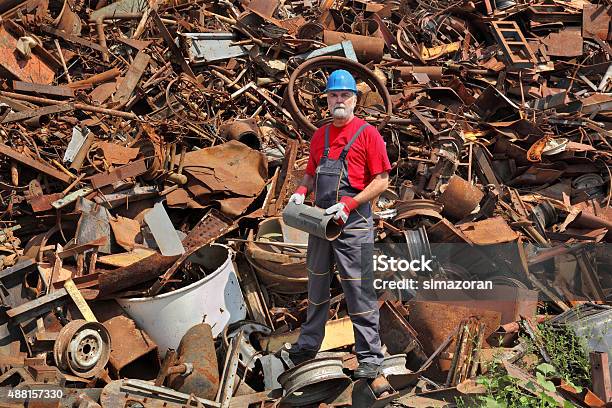 Recycling Industry Worker Stand At Heap Of Old Metal Stock Photo - Download Image Now