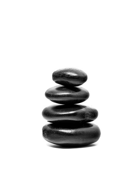 istock Close up Stack of spa hot stones isolated on white 488157452