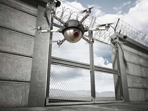 3d image of security border line gate with razor wire and drone