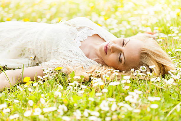 istock Beautiiful woman lying down on the grass 488158541
