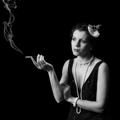 Vintage 1920s lady smoking a cigarette with a mouthpiece