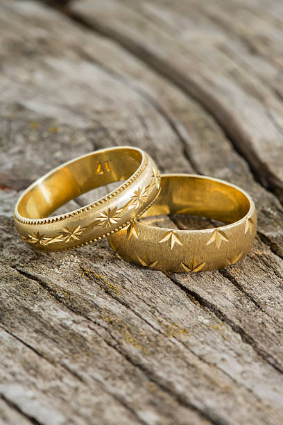 istock Wedding rings on wooden background 488174321