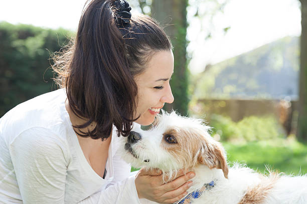 istock Girl having fun with dog 488175629