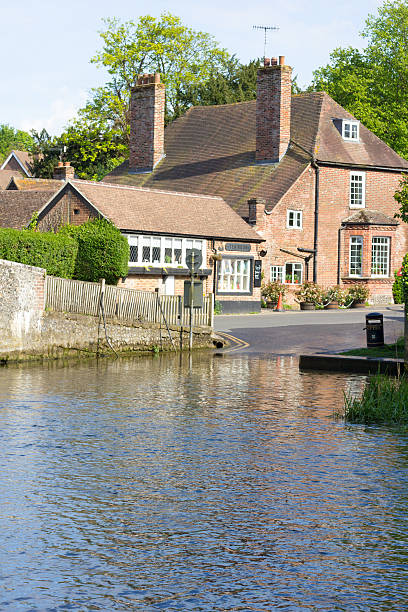 Oxford, UK: May 07, 2014: The Head of the River is a popular gastro pub set on the River Thames at Oxford, providing meals and accommodation. People sit and enjoy a drink with a view in the outdoor beer garden.