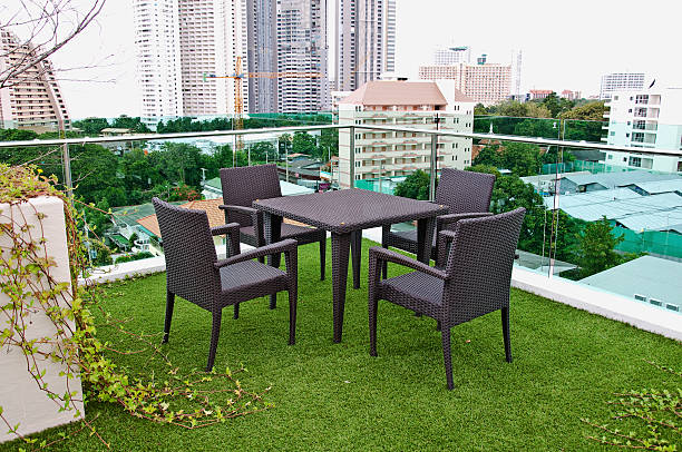 istock Table and chairs on apartment top terrace 488176759