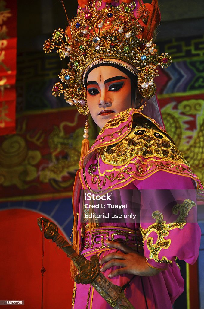 Chinese Opera team acting at The Chinesse Temple Nonthaburi, Thailand- March 13, 2011 : Actress Chinese opera performer is on a small stage for Celebration Festival of Chinese temple in Nonthaburi, Thailand. Chinese Opera Stock Photo